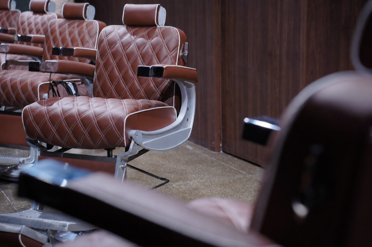 Quilted leather barber chairs at The Upper Seat shave and grooming club near Penn Station