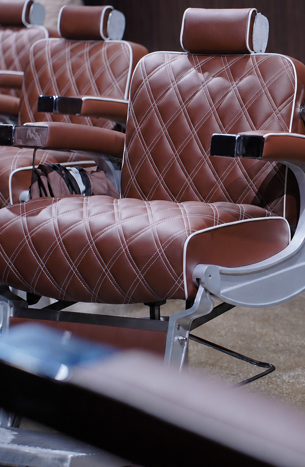 Quilted leather barber chairs at The Upper Seat, premium barbershop on West 37th Street near Penn Station