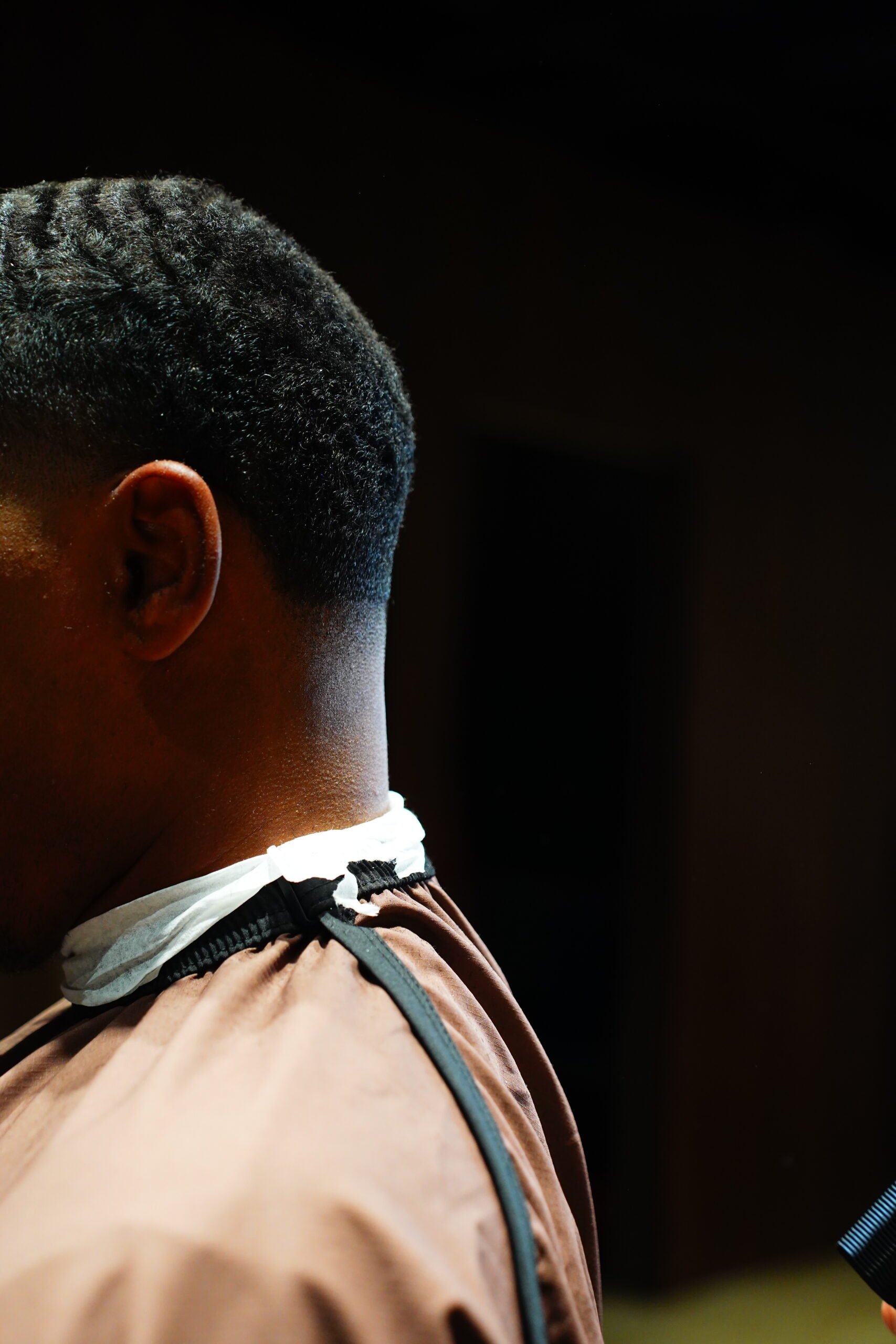 Fresh taper haircut with a clean neckline at The Upper Seat, men's barbershop near Penn Station NYC