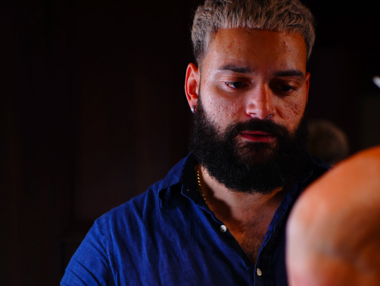 Barber with a groomed moustache and beard at The Upper Seat, Midtown Manhattan